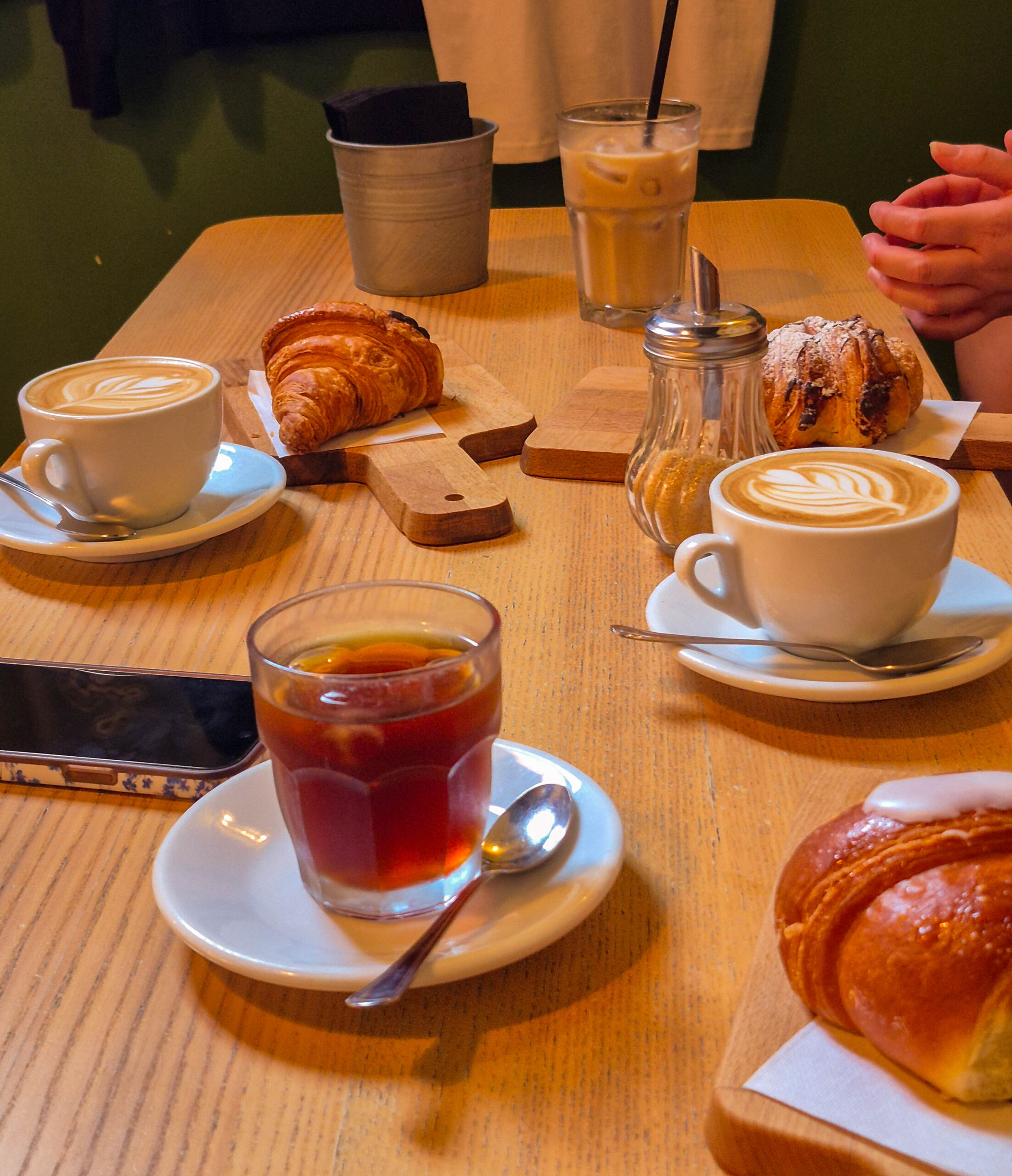 table full of coffee and croissants